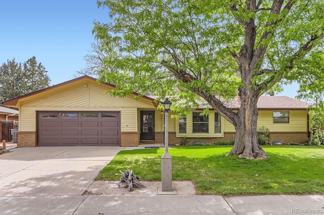 2310 Squires Ct, Longmont, CO 80501 - view of front of house with brick siding, a garage, driveway, and a front lawn