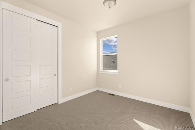 unfurnished bedroom with carpet floors and a closet