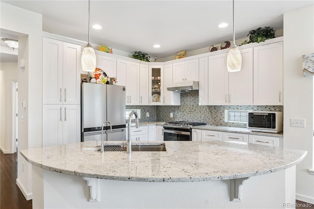 kitchen featuring white cabinets, decorative light fixtures, sink, and appliances with stainless steel finishes