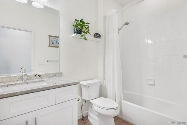 full bathroom with hardwood / wood-style floors, vanity, toilet, and shower / bath combo with shower curtain