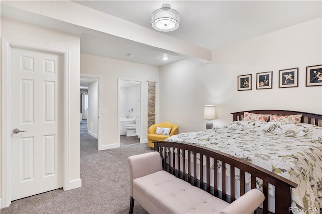 bedroom with carpet flooring and connected bathroom