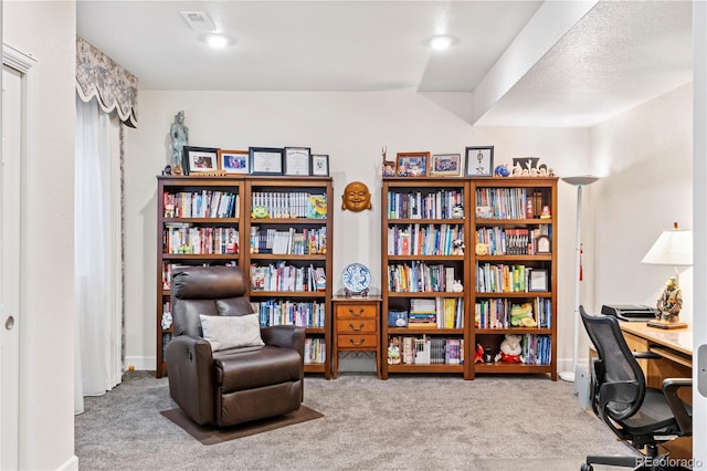 office area with a textured ceiling and carpet floors