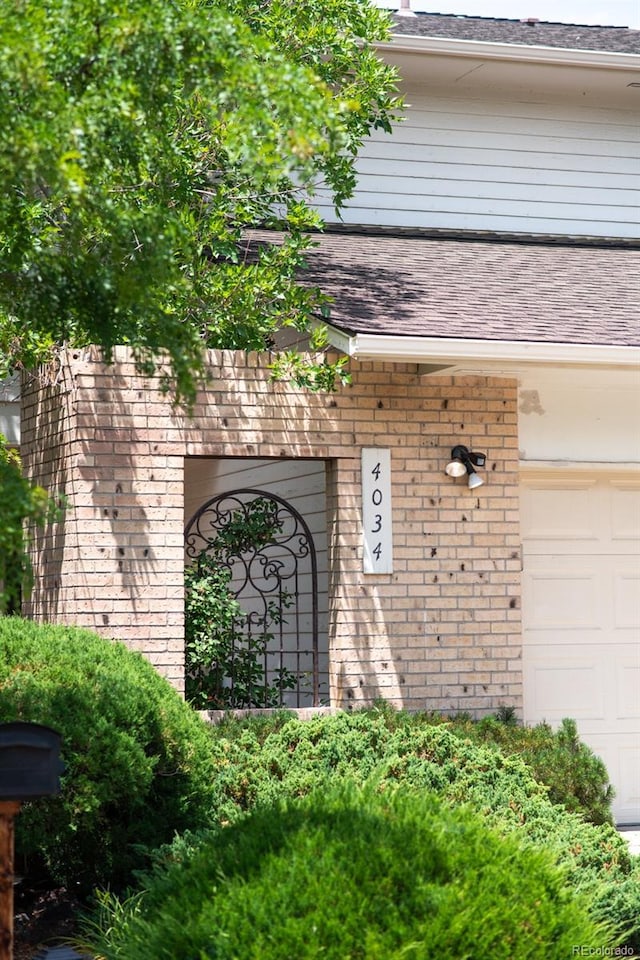 4034 S Atchison Way, Aurora, CO 80014 - exterior view of a shingled roof, brick siding, and gutters