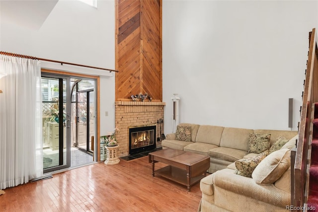 4034 S Atchison Way, Aurora, CO 80014 - living room featuring a high ceiling, wood finished floors, and a fireplace