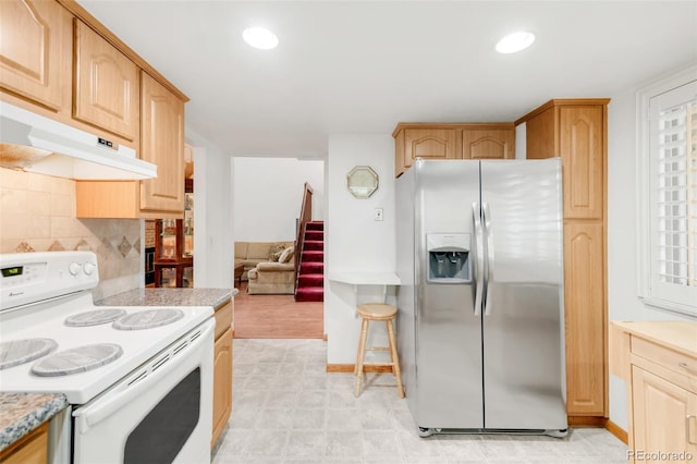 4034 S Atchison Way, Aurora, CO 80014 - kitchen featuring stainless steel fridge, electric range, light countertops, backsplash, and under cabinet range hood