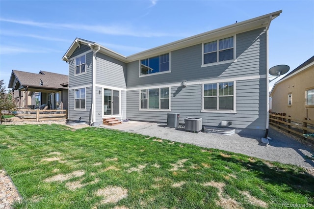 back of house featuring central AC unit, a lawn, and a patio