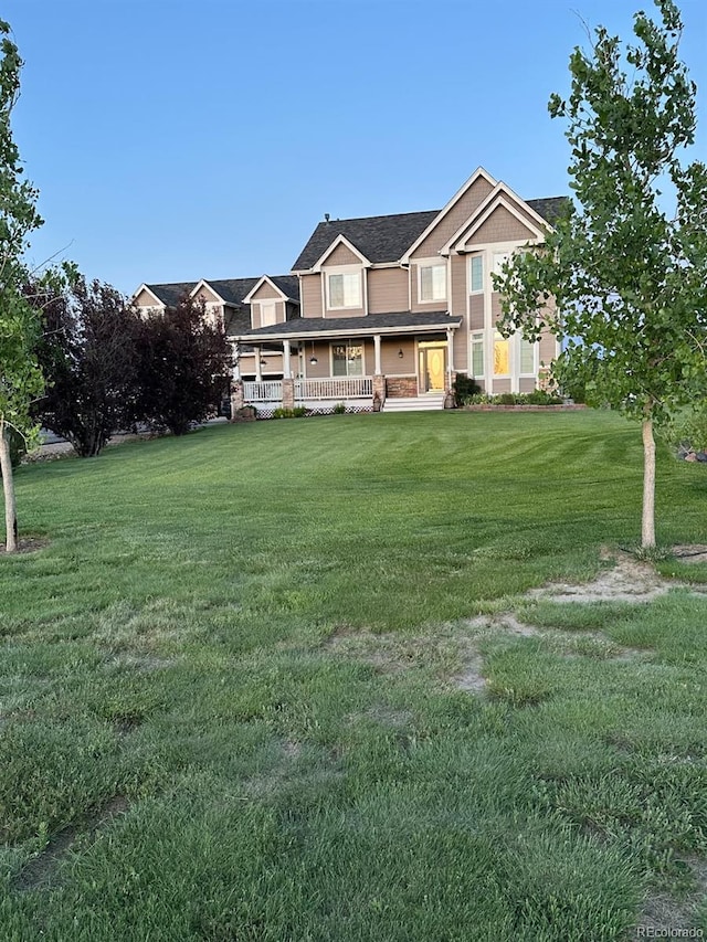 970 Inyokern Ct, Watkins, CO 80137 - view of front facade featuring a porch and a front yard