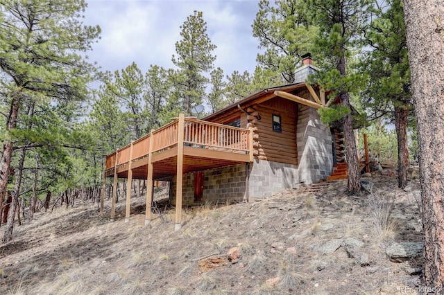 307 Virginia Rd, Bailey, CO 80421 - view of home's exterior with a chimney, a wooden deck, and log exterior