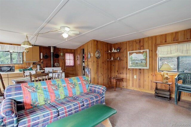 307 Virginia Rd, Bailey, CO 80421 - carpeted living room with wooden walls and ceiling fan