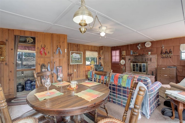 307 Virginia Rd, Bailey, CO 80421 - dining room featuring a brick fireplace, wood walls, and a ceiling fan