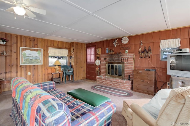 307 Virginia Rd, Bailey, CO 80421 - living area featuring a fireplace, wood walls, and carpet flooring