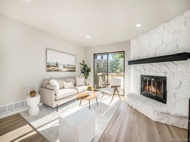 living room with a fireplace and light hardwood / wood-style floors