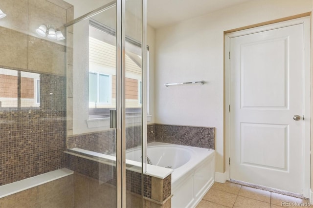 bathroom featuring tile patterned flooring and independent shower and bath