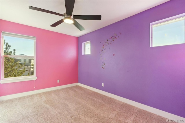 empty room with carpet flooring and ceiling fan