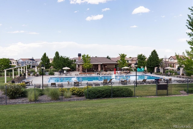 view of pool featuring a lawn and a patio