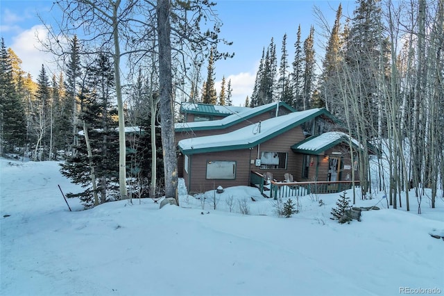 view of snow covered back of property