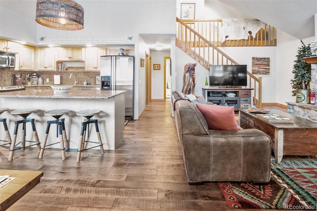 interior space with a high ceiling, dark hardwood / wood-style floors, and sink