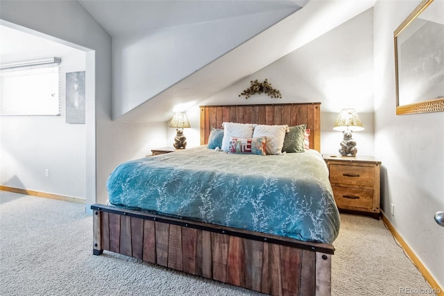 bedroom featuring vaulted ceiling and light carpet