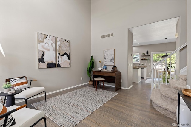 8982 Miners Pl, Highlands Ranch, CO 80126 - sitting room with stairway, dark wood-type flooring, and a towering ceiling