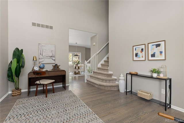 8982 Miners Pl, Highlands Ranch, CO 80126 - foyer entrance with wood finished floors, stairs, and a towering ceiling