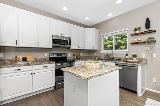 8982 Miners Pl, Highlands Ranch, CO 80126 - kitchen with appliances with stainless steel finishes, dark wood-type flooring, white cabinetry, light stone counters, and recessed lighting