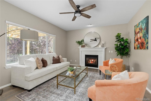 8982 Miners Pl, Highlands Ranch, CO 80126 - living room featuring wood finished floors, ceiling fan, and a glass covered fireplace