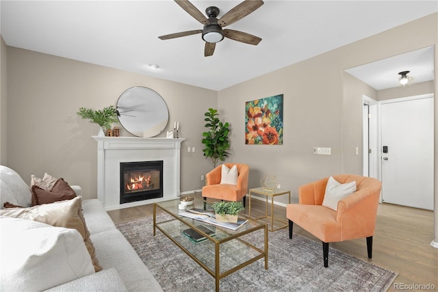 8982 Miners Pl, Highlands Ranch, CO 80126 - living room with wood finished floors, ceiling fan, and a glass covered fireplace