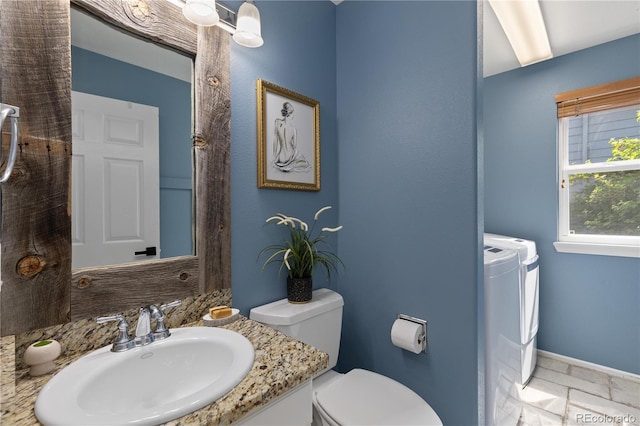 8982 Miners Pl, Highlands Ranch, CO 80126 - bathroom featuring washer and clothes dryer and vanity