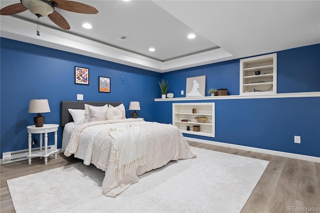 8982 Miners Pl, Highlands Ranch, CO 80126 - bedroom with a baseboard radiator, recessed lighting, wood finished floors, a raised ceiling, and ceiling fan