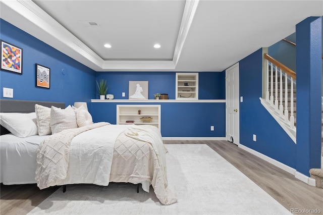 8982 Miners Pl, Highlands Ranch, CO 80126 - bedroom with wood finished floors, a tray ceiling, and recessed lighting