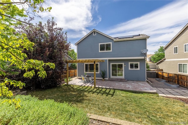 8982 Miners Pl, Highlands Ranch, CO 80126 - rear view of property featuring roof mounted solar panels, a pergola, a patio, and a fenced backyard