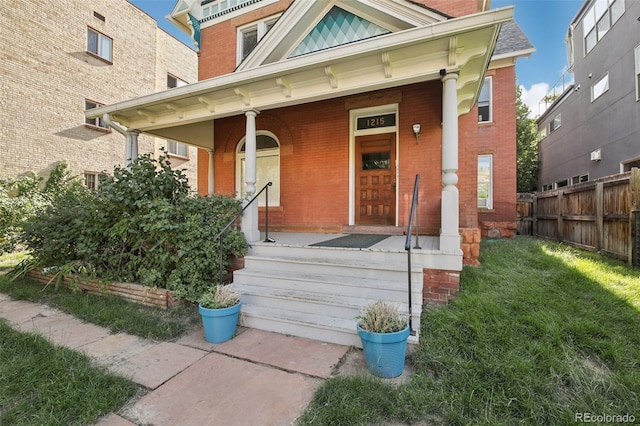 1215 N Emerson St Unit A, Denver, CO 80218 - doorway to property featuring brick siding and covered porch