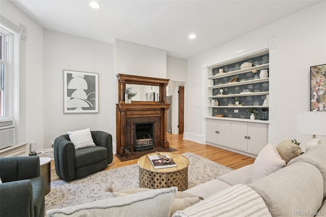 1215 N Emerson St Unit A, Denver, CO 80218 - living room with light wood-type flooring, recessed lighting, built in features, and a fireplace with flush hearth