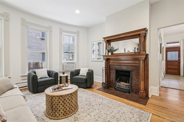 1215 N Emerson St Unit A, Denver, CO 80218 - living room featuring wood finished floors, a fireplace, recessed lighting, baseboard heating, and cooling unit