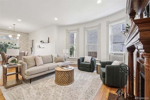 1215 N Emerson St Unit A, Denver, CO 80218 - living area with light wood-type flooring, a fireplace, a chandelier, cooling unit, and recessed lighting