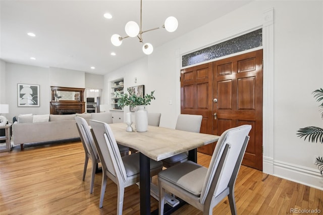1215 N Emerson St Unit A, Denver, CO 80218 - dining room with light wood finished floors, recessed lighting, a chandelier, and built in features