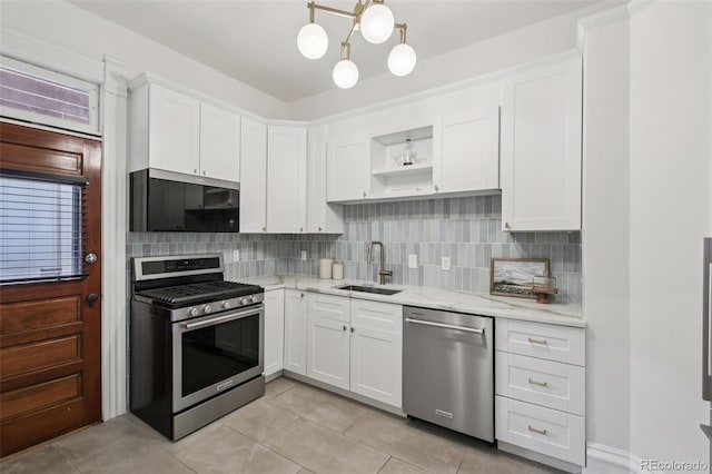 1215 N Emerson St Unit A, Denver, CO 80218 - kitchen with appliances with stainless steel finishes, open shelves, white cabinets, light tile patterned floors, and tasteful backsplash