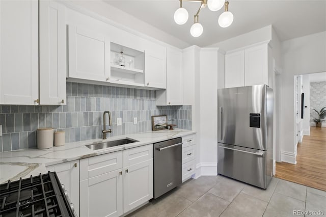 1215 N Emerson St Unit A, Denver, CO 80218 - kitchen featuring appliances with stainless steel finishes, white cabinetry, light tile patterned floors, open shelves, and backsplash