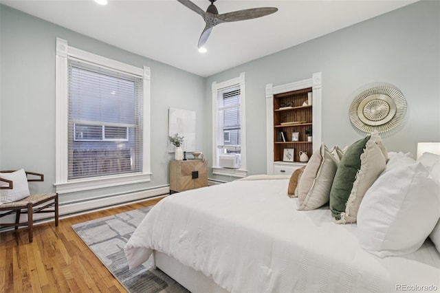1215 N Emerson St Unit A, Denver, CO 80218 - bedroom with a baseboard radiator, recessed lighting, wood finished floors, and a ceiling fan