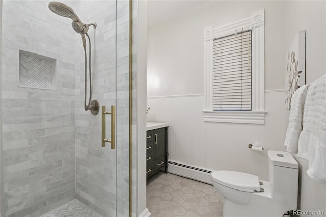 1215 N Emerson St Unit A, Denver, CO 80218 - bathroom with baseboard heating, a shower stall, wainscoting, vanity, and tile patterned floors