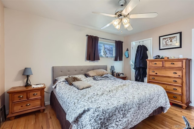 bedroom with ceiling fan, a closet, and light hardwood / wood-style flooring