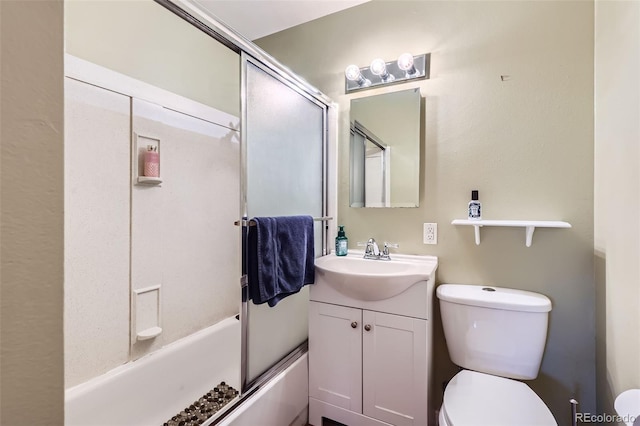 full bathroom featuring shower / bath combination with glass door, vanity, and toilet