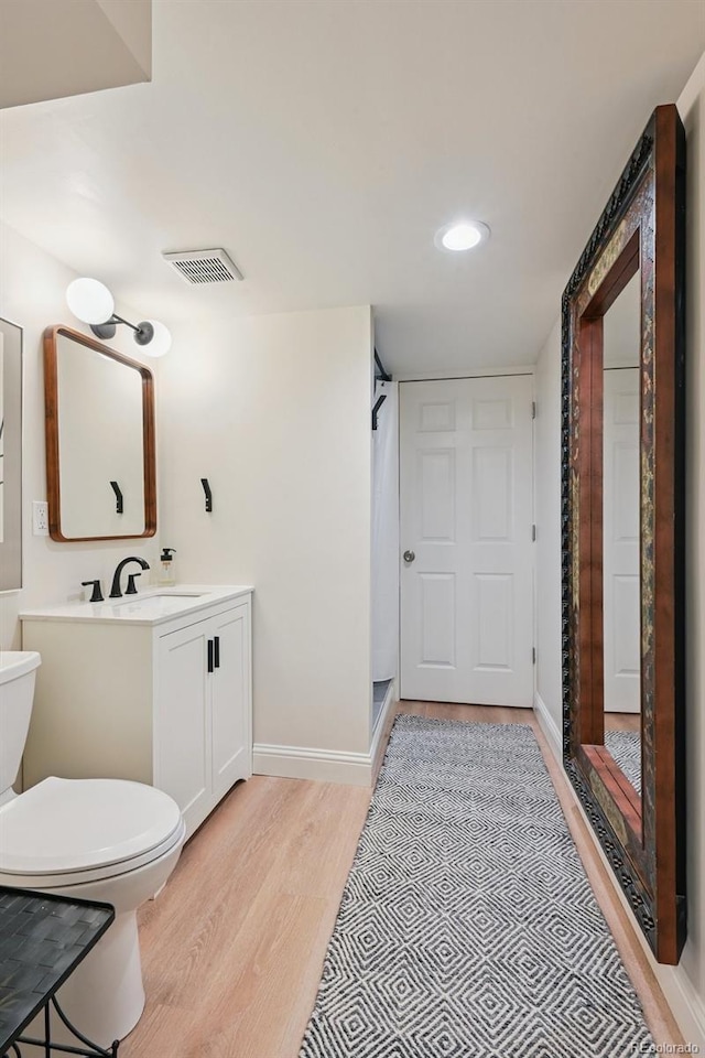 2965 S Gilpin St, Denver, CO 80210 - full bathroom with wood finished floors, vanity, a stall shower, and recessed lighting