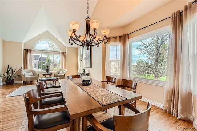 19770 E Geddes Pl, Centennial, CO 80016 - dining room with a chandelier, plenty of natural light, lofted ceiling, baseboards, and light wood-type flooring