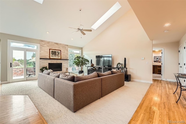 19770 E Geddes Pl, Centennial, CO 80016 - living area with a skylight, high vaulted ceiling, light wood-type flooring, a large fireplace, and a ceiling fan