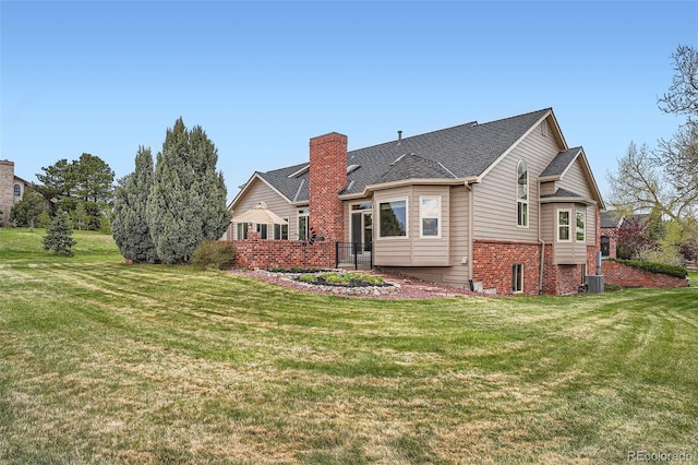 19770 E Geddes Pl, Centennial, CO 80016 - rear view of house with a lawn, a chimney, brick siding, and cooling unit