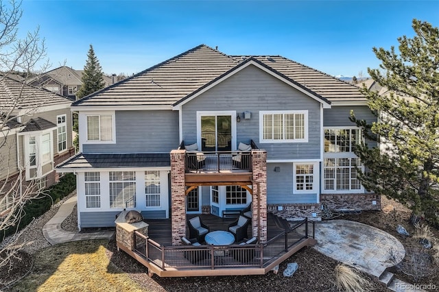 back of property with a balcony