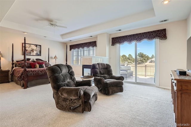 bedroom with visible vents, light carpet, a raised ceiling, access to outside, and baseboards