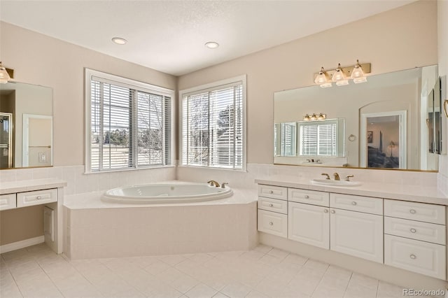 full bath featuring a bath, tile patterned flooring, recessed lighting, and vanity