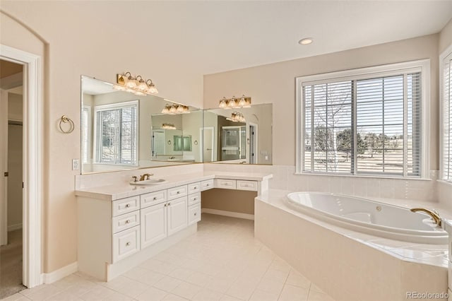 bathroom featuring tile patterned flooring, vanity, and a garden tub